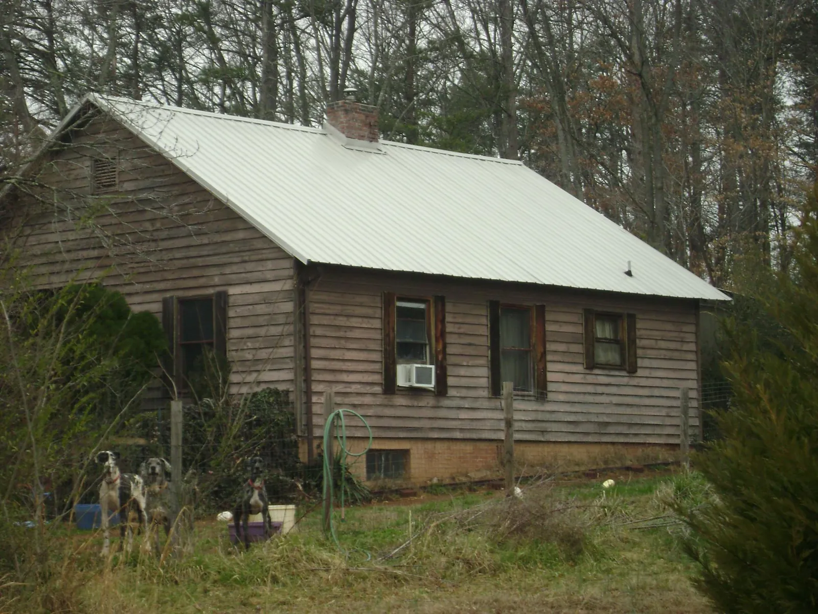 White metal roof on an old wood sided farmhouse, from a Metal Roof Installation job in Sag Harbor